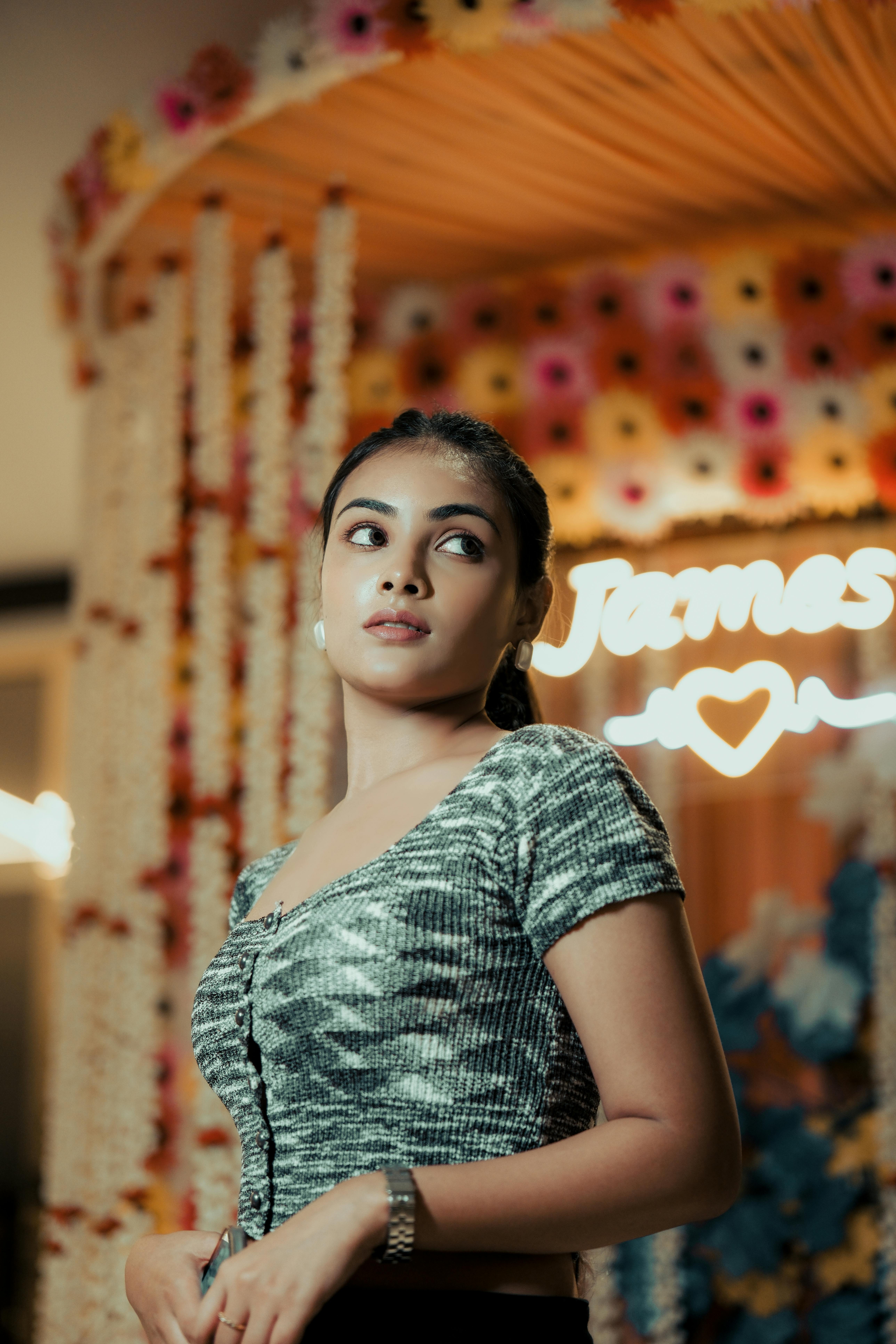 A stylish woman posing confidently against a vibrant floral backdrop. She is client of Digital Marketing Specialist. her name isw anshika