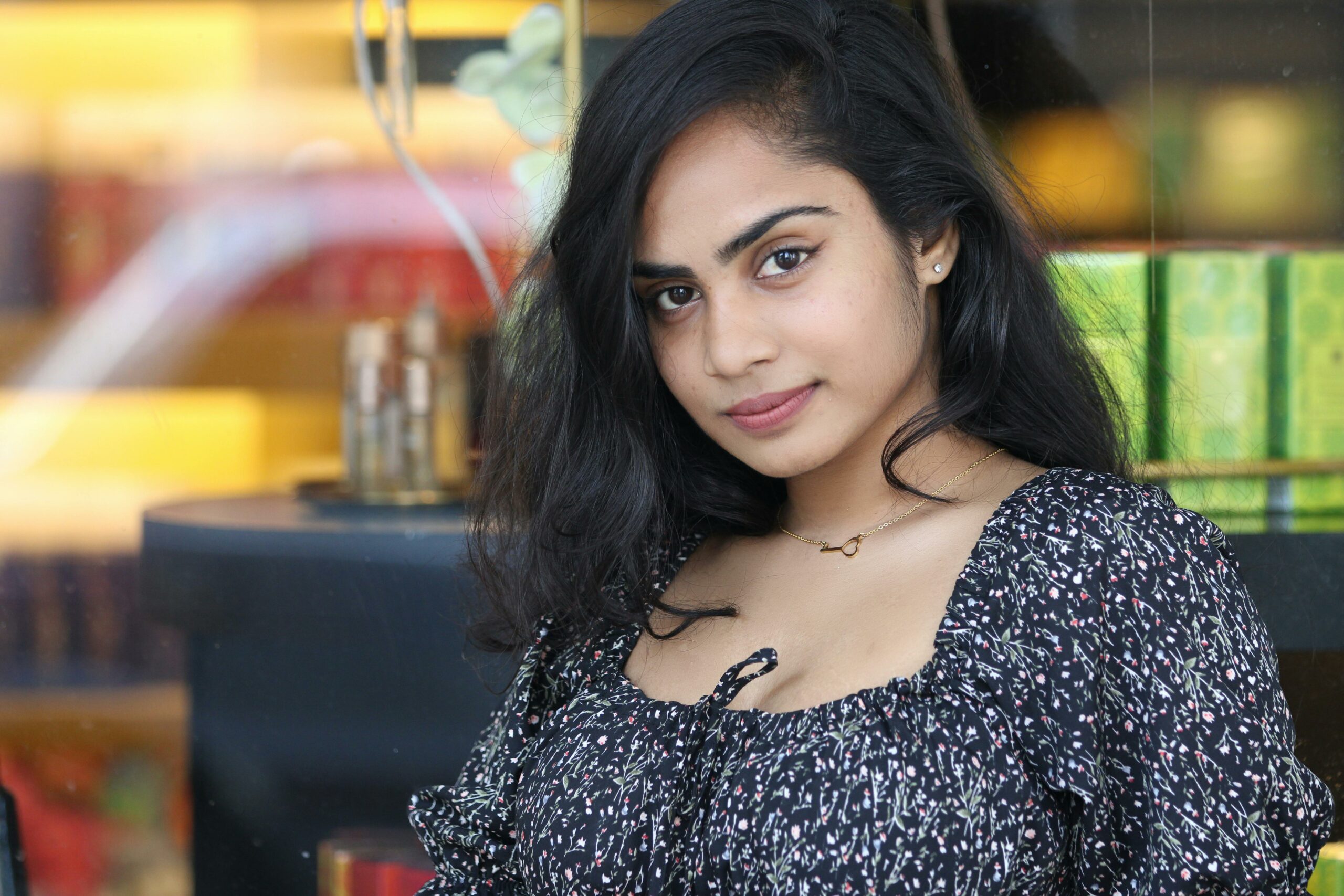 Elegant portrait of a woman with a gentle smile indoors named Diksha